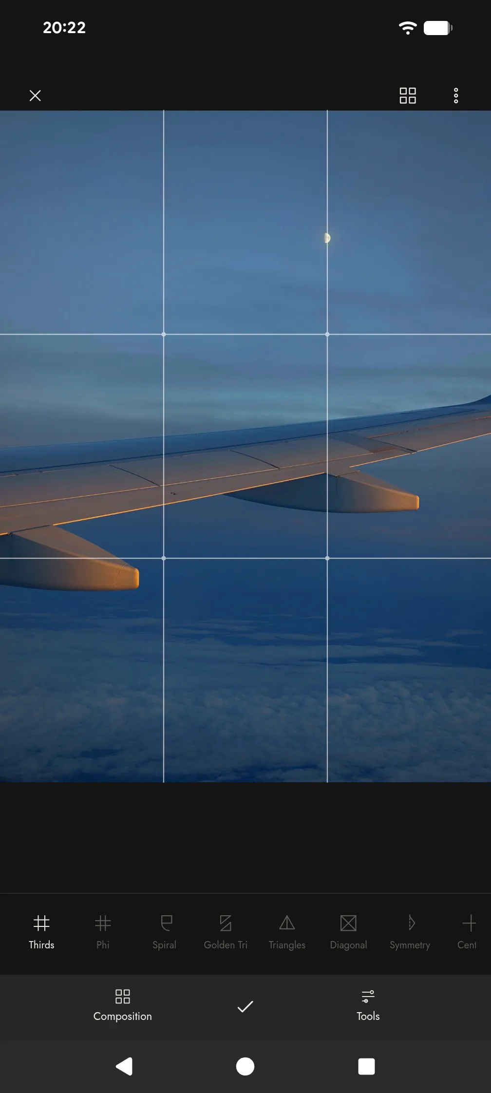 Rule of thirds guide over an aircraft wing at dusk